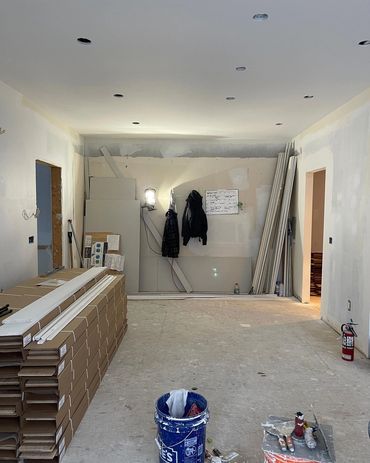 Finish coat of mud being applied to drywall in a main floor remodel
