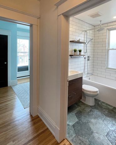 Natural colours and lighting, matched with light brown grout and floating wood vanity make this pop