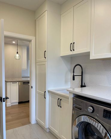 Custom laundry room looking into custom kitchen. Penny tile back splash 