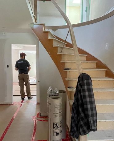 Main floor remodel with a new stair case, with a curved hand rail. 
