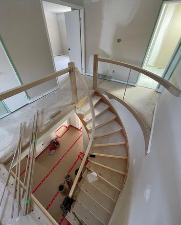 Beautiful curved staircase and railings built out of oak. In a home we remodel in Cambridge, ontario