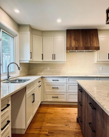 Large welcoming kitchen with walnut island and range hood. Located in Kiwanis Park, Kitchener