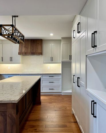 Large welcoming kitchen with walnut island and range hood. Located in Kiwanis Park, Kitchener