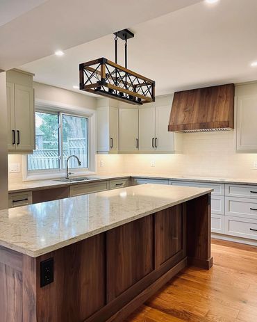 Large welcoming kitchen with walnut island and range hood. Located in Kiwanis Park, Kitchener