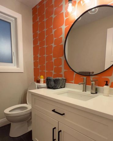 Funky wallpaper makes this washroom pop! With the black round mirror makes the retro feel work 