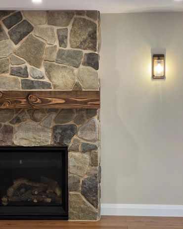 Custom gas fire place with a beautiful stone and wood mantel. 