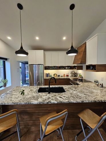 Grain matched walnut cabinetry with  quartzite countertops. Functional open shelving. Mount Hope