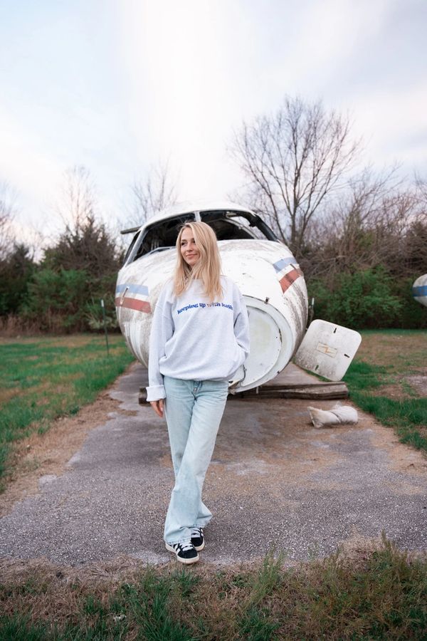 girl standing in front of airplane