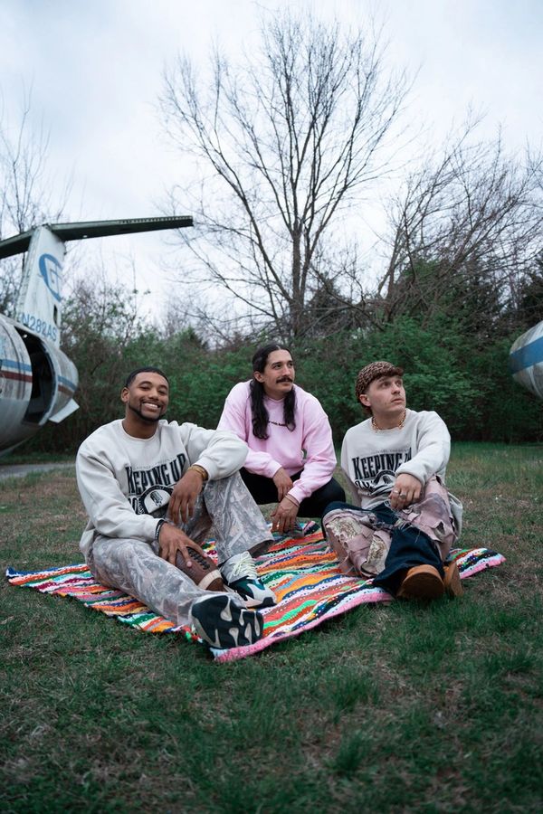 guys sitting on a blanket