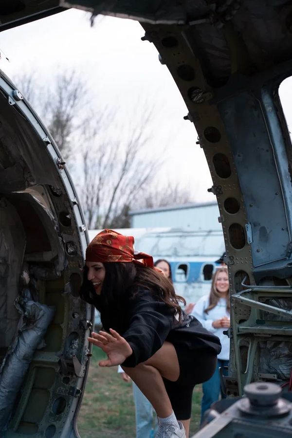 girl climbing into airplane