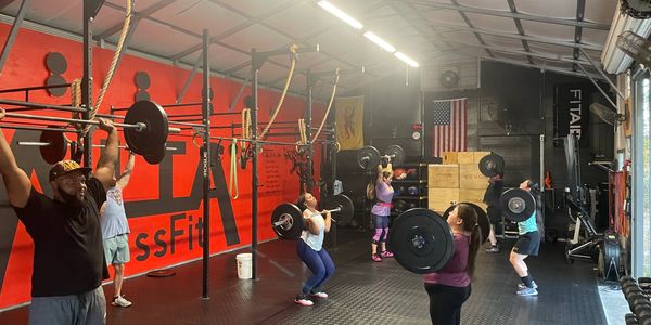 Diverse group of people doing CrossFit at Alta CrossFit
