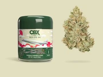 Container of CBX Red Eye OG cannabis flower next to a cannabis bud.