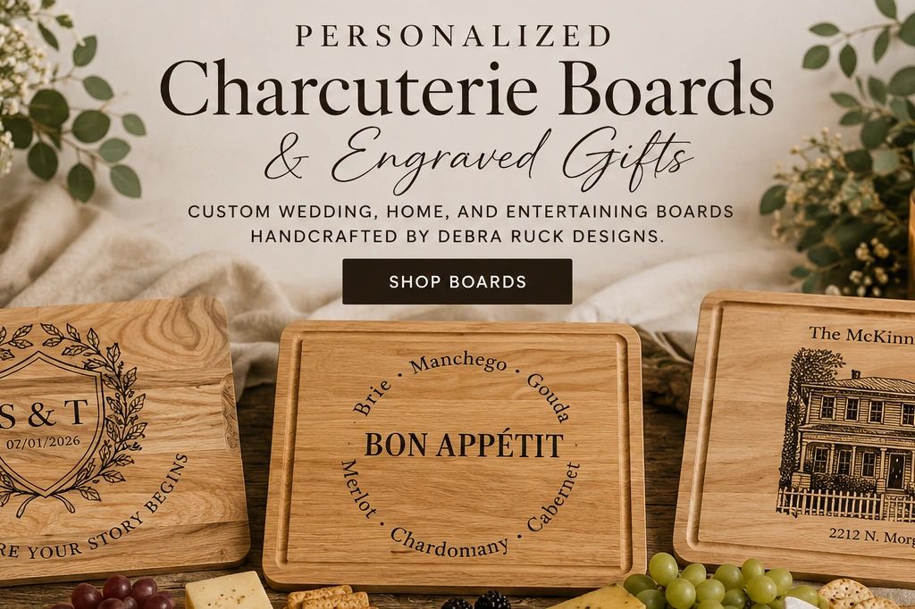  Three personalized engraved charcuterie boards by Debra Ruck Designs.