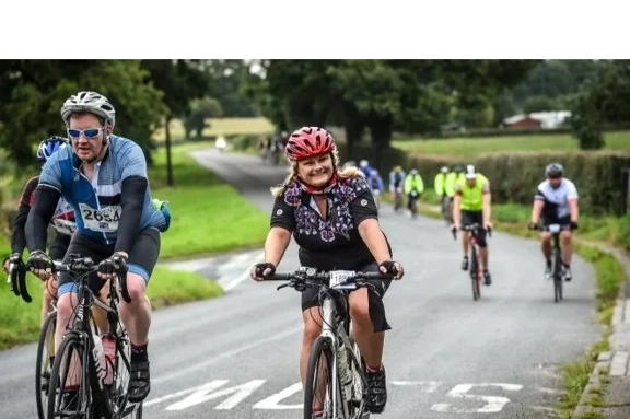 Cyclists riding on a countryside road.