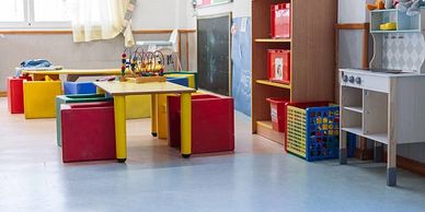 Colorful kids' play area with tables and toys.