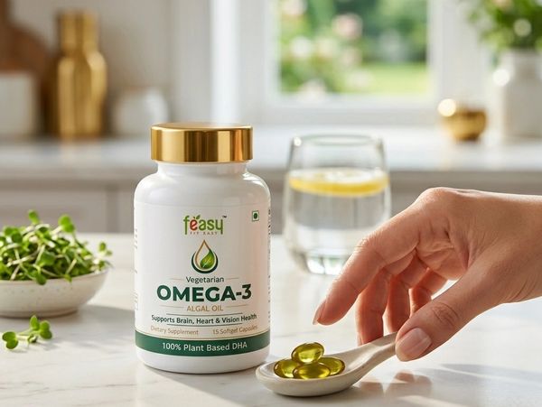 A bottle of Feasy Omega-3 algal oil capsules with a hand holding a spoon of capsules.