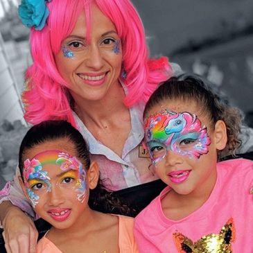 A picture of Jacqueline Howe and two children with painted faces.
