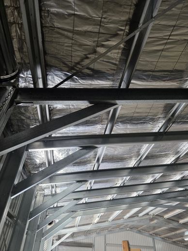 Interior view of a metal-framed ceiling with insulation panels.