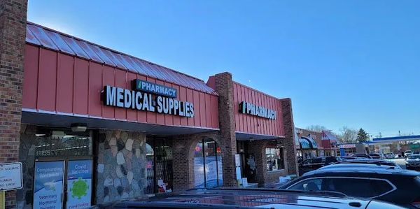 Exterior view of iPharmacy showing the drug store and medical supplies sign displays.