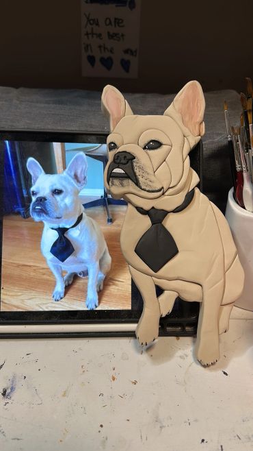 A dog photo and matching dog sculpture with tie.