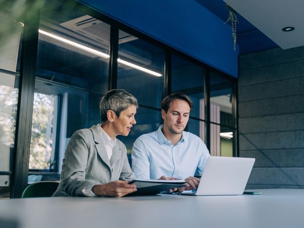 Colleagues discussing project at workplace