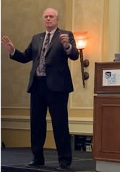 Man giving a presentation in a suit.
