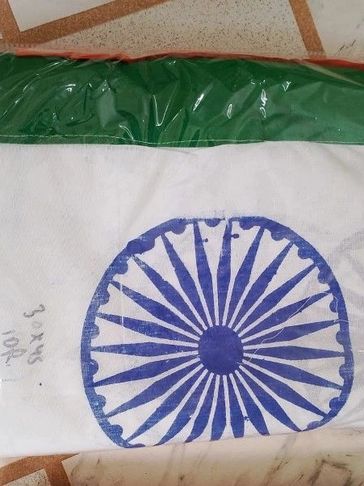 Packaged Indian flag with visible Ashoka Chakra and tricolor.
