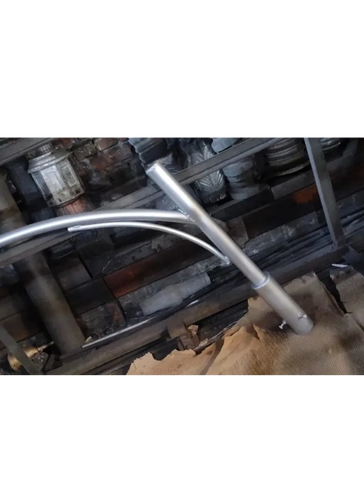 Metal pipes and tubes arranged inside a workshop setting.