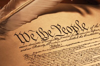 Close-up of the U.S. Constitution with a quill pen.
