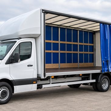 Side view of an empty box truck with open side curtain.