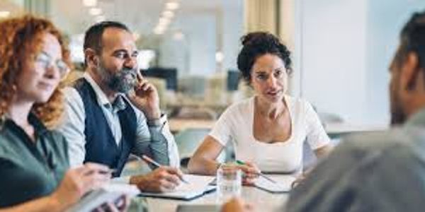 Four professionals engaged in a meeting at a modern office.