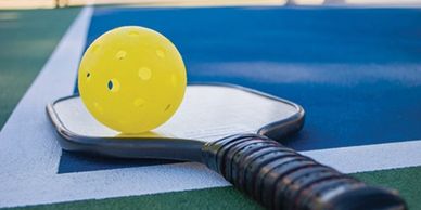 Pickleball and paddle on a court