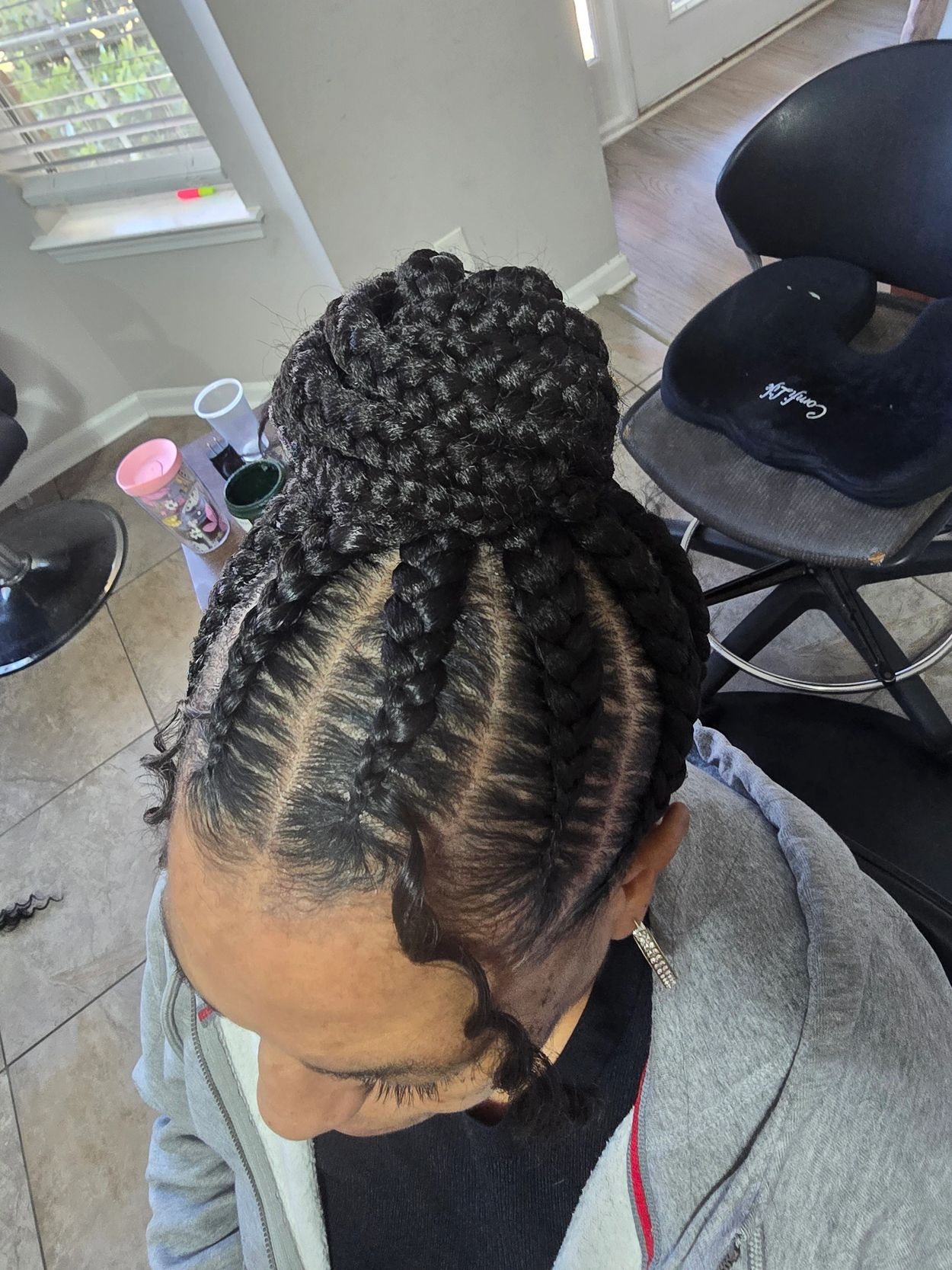 Intricate braided hairstyle styled into a bun with baby hairs laid.