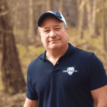 Patoma Co-Founder John Patalano Sr. standing in-front of a natural forest background.