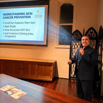 Man giving presentation on skin cancer prevention.