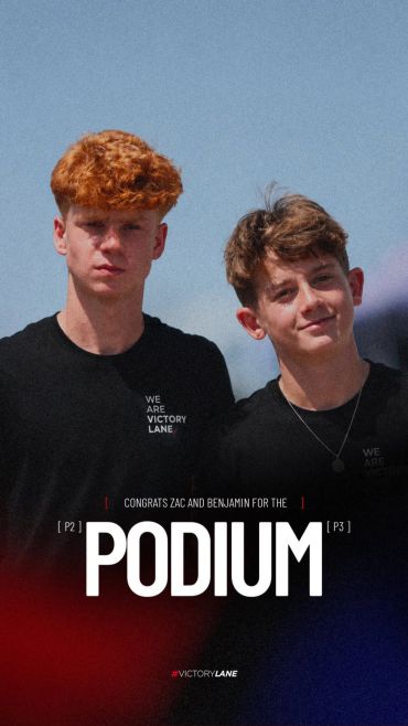 Two boys celebrating podium finishes with 'Victory Lane' shirts.