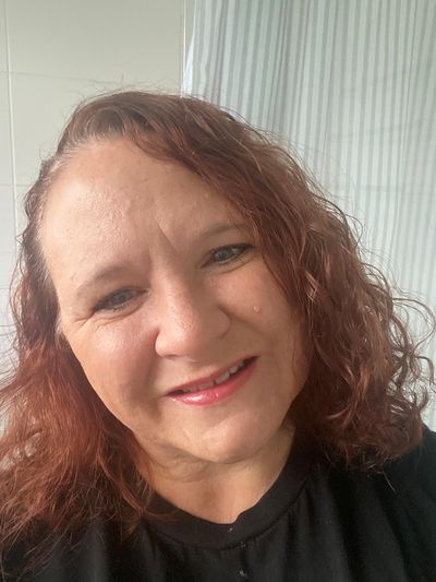 Jane Harvey smiling with brown curly hair.