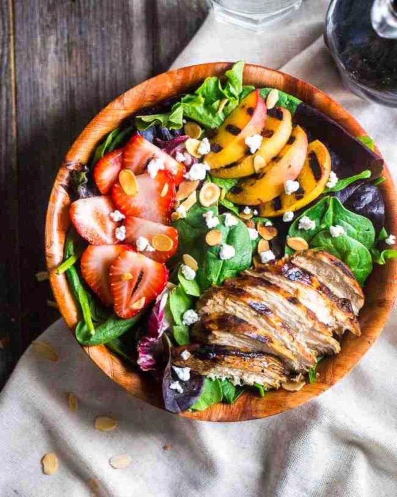 Grilled chicken salad with strawberries, grilled peaches, greens, almonds, and cheese availible from Maryland meal prep service. best meal prep in baltimore 