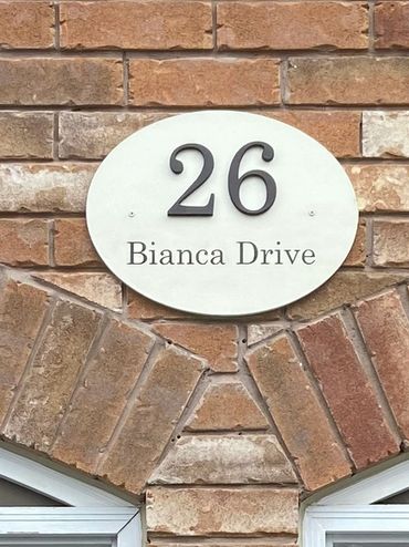 Custom wood house sign with contrasting white backing and dark brown number and street name