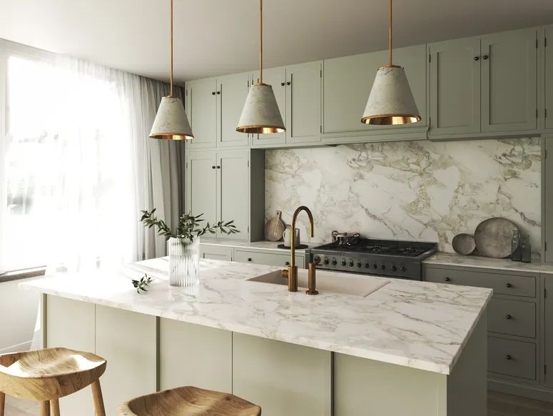 Green kitchen with marble-effect worktops and island – Osprey Interiors