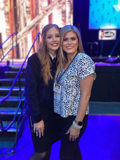 Two women smiling and posing together at an event.