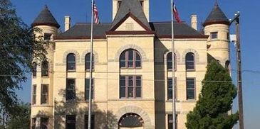 Historic courthouse building with clock tower.