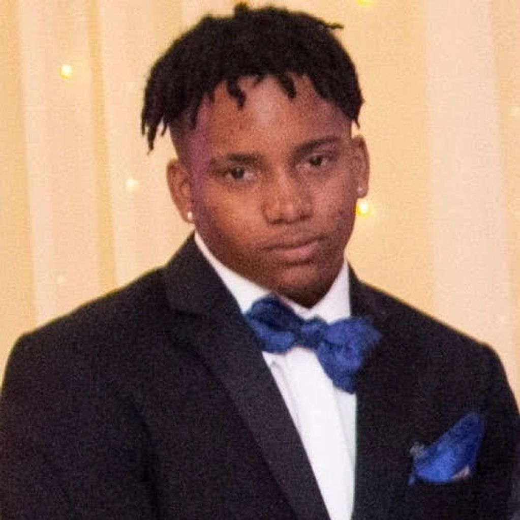Young man in a black tuxedo with a blue bow tie and pocket square.