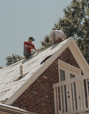 two roofers on a house