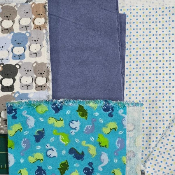 Five pieces of fabric with different patterns and colors.
