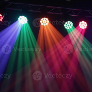 Colorful stage lights shining in purple, green, orange, and red hues.