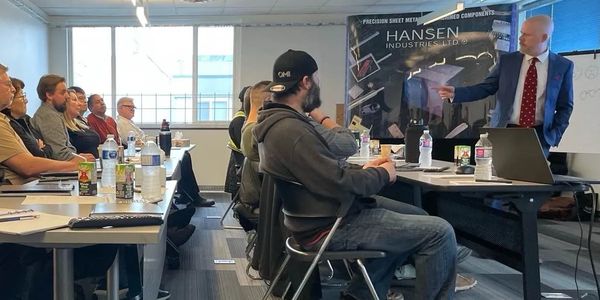 A group attending a business presentation in a modern conference room.