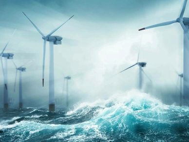 Offshore wind turbines standing tall amid rough ocean waves.