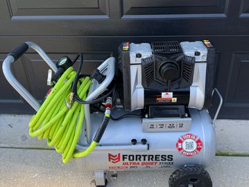 Fortress Ultra Quiet air compressor with green hose. 
10 Gallon Electric Air Compressor for rent
