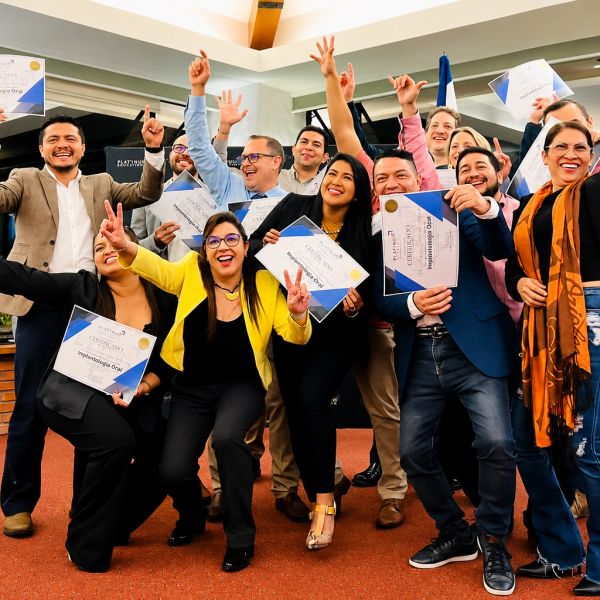 Group celebrating success while holding certificates indoors.